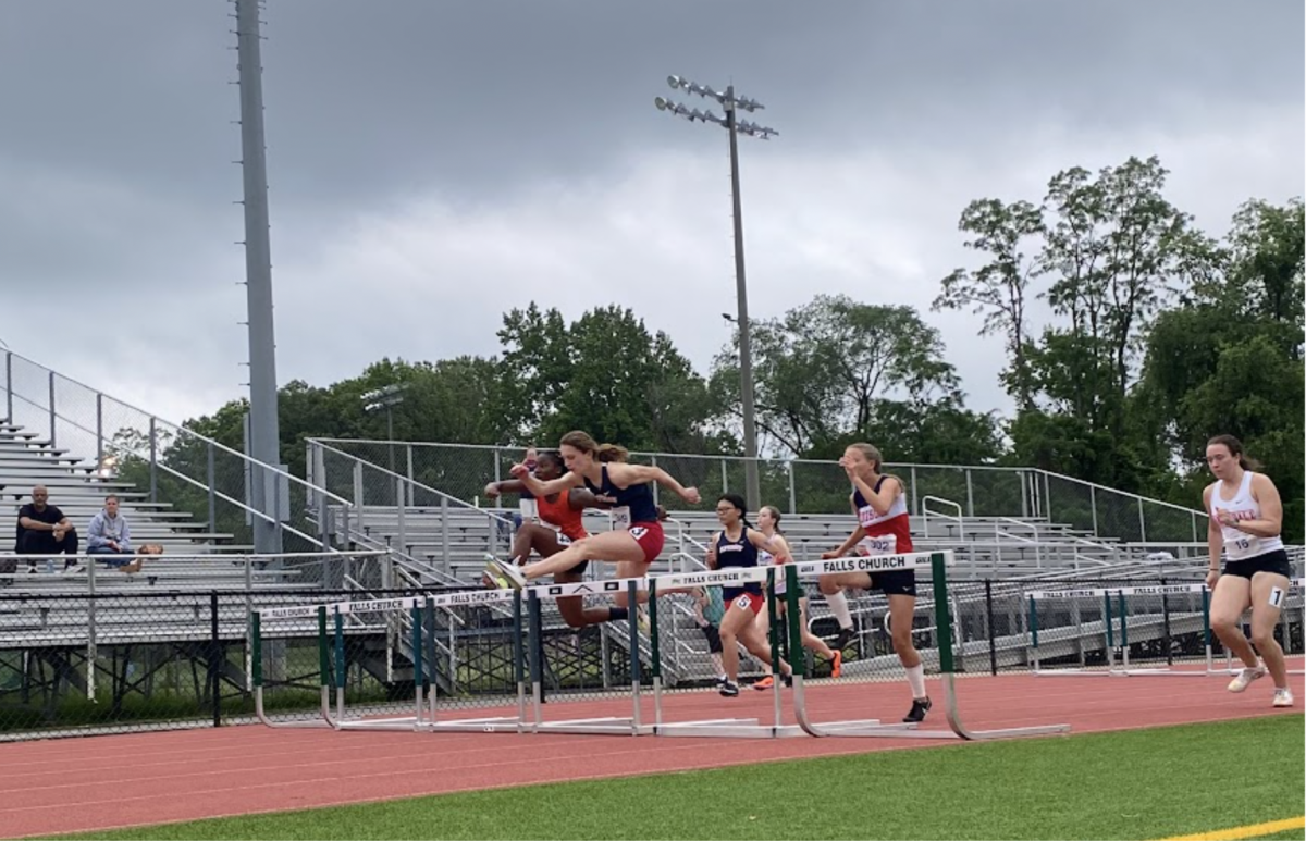 Jumping over a hurdle, junior Breanne Graham races through the 100-meter hurdles at the district meet on May 14. What began as simple conditioning turned into a passion that led her to become a team captain. “Hurdles are just fun, and I love the rhythm and technique that go into every jump,” Graham said.
