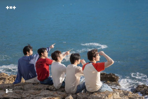 Looking off into the coast, TOMORROW X TOGETHER (TXT) are pictured in Spain for their new digital single “Love Language.”