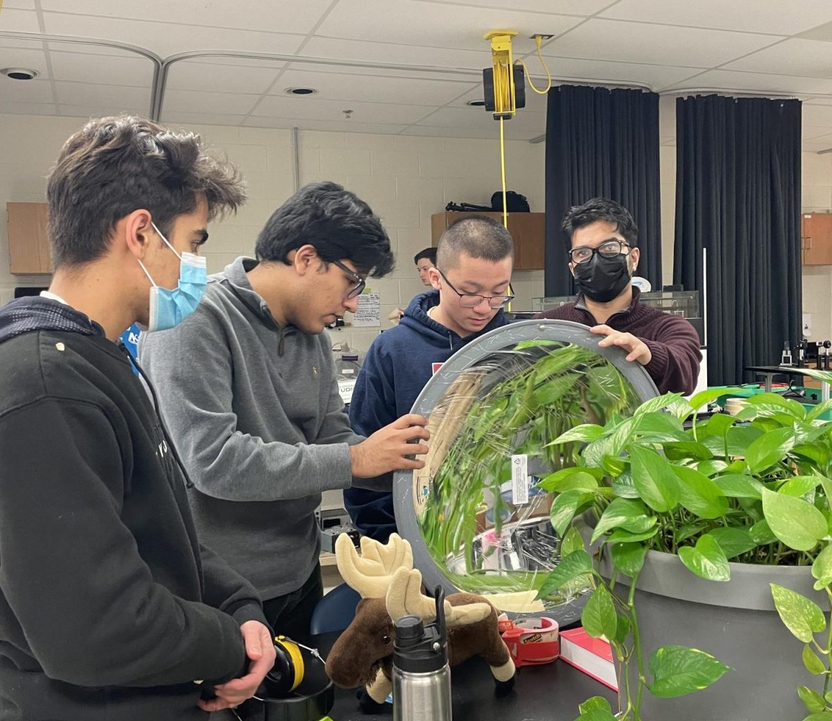 Taking the plastic wrap off of the mirror, senior Tahir Ahmad, senior Cristian Vargas, junior Thien Dao and senior Jahin Hasan get the Optics materials ready to use. Many students come into the class with different levels of experience, thus hoping to get different outcomes from the class as well. “I definitely want to be able to explain stuff about light that I wouldn’t have been able to explain as well when I was a junior, and be able to meet new people and try to help the sophomores as well,” Vargas said.