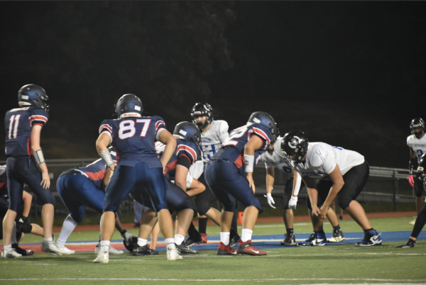 Jefferson's varsity football team and Northern Virginia Homeschool line up before the next play. 