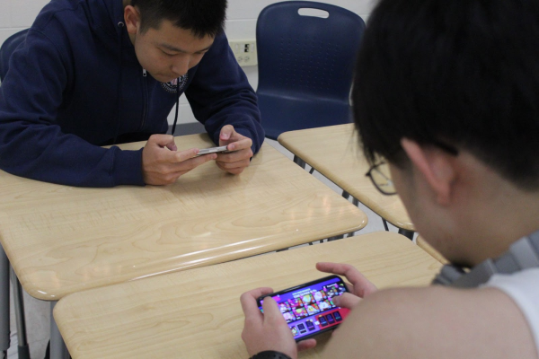 Freshman Michael Zhou and senior Justin Liu play Brawl Stars at lunch. “Over the past four years at [Jefferson], I [haven't] really played [Brawl Stars], I’ve only recently redownloaded the game for the homecoming tournament,” Yu said.