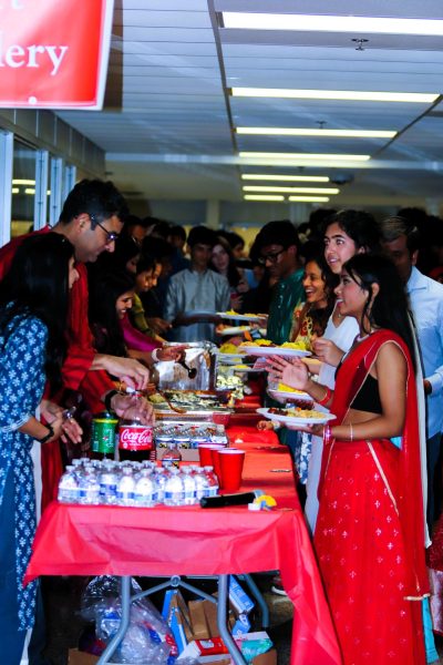 Juniors Raksha Komakula and Richita Shukla get food after the Diwali festival. “Performing at Diwali was so much fun and even though I didn’t have too much time to practice,” junior Richita Shukla said.