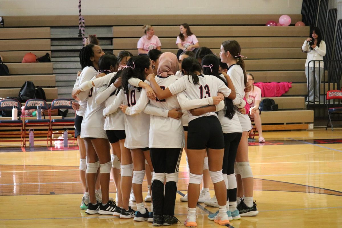 Jefferson girls freshman volleyball team huddles and exchanges strategy before the game. “Collaboration and communication [are] very important in [volleyball],” Li said.