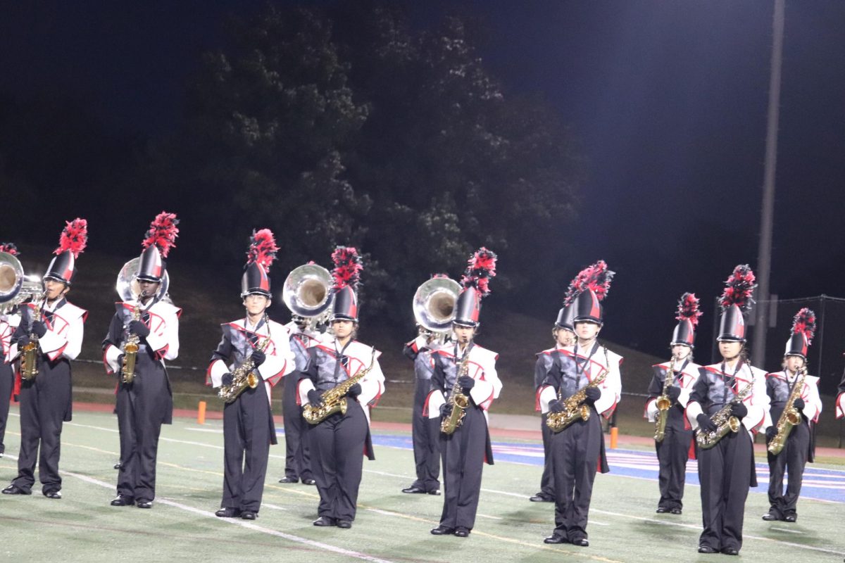 The Jefferson Marching Colonials perform at the 40th anniversary football game on Oct. 24. “The most important parts for a horn line would be music quality, tone quality, breath control and the visual aspect,” senior Drum Major Grace Bai said. 