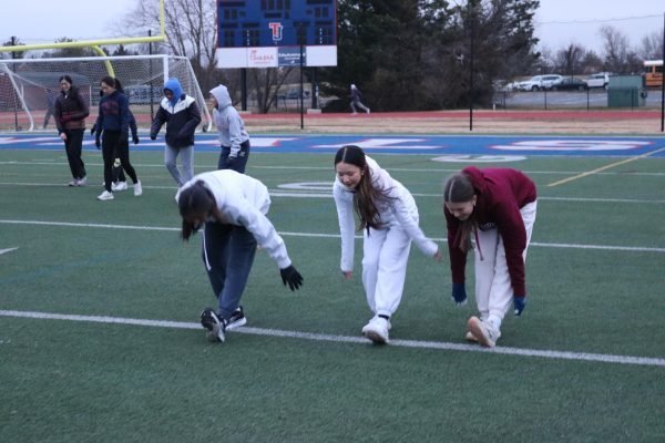 Despite freezing cold temperatures, freshmen Ashley Yan, Milly Tran and Jaime Baker warm up for track practice. “It's really important to give it your all [when you’re] practicing,” Yan said. “It can determine how you perform at a meet.”