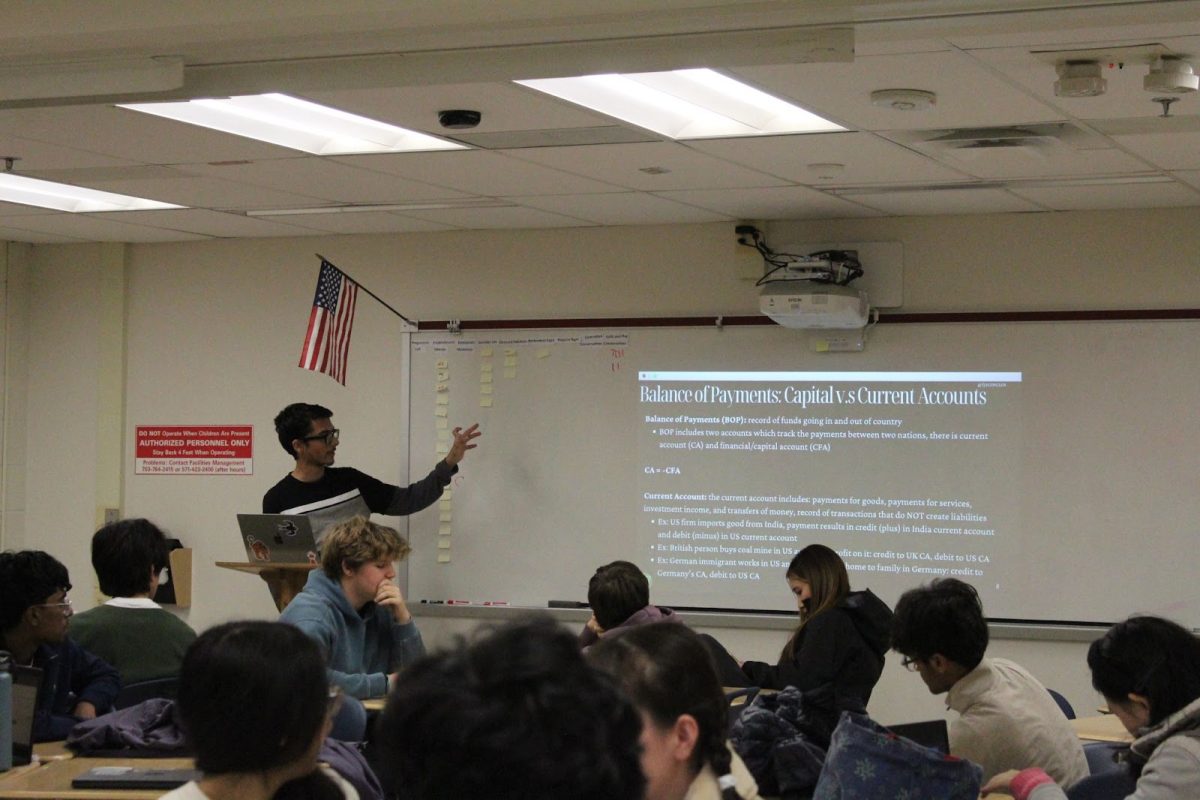 Sophomore secretary Paribes Kharel reviews key strategies on the board as members take notes during the meeting. The session focused on preparing the team for upcoming competitions and strengthening foundational skills. “An econ club meeting would normally begin with any announcements for the week. After that, we normally start lectures,” junior secretary Sam Lam said.