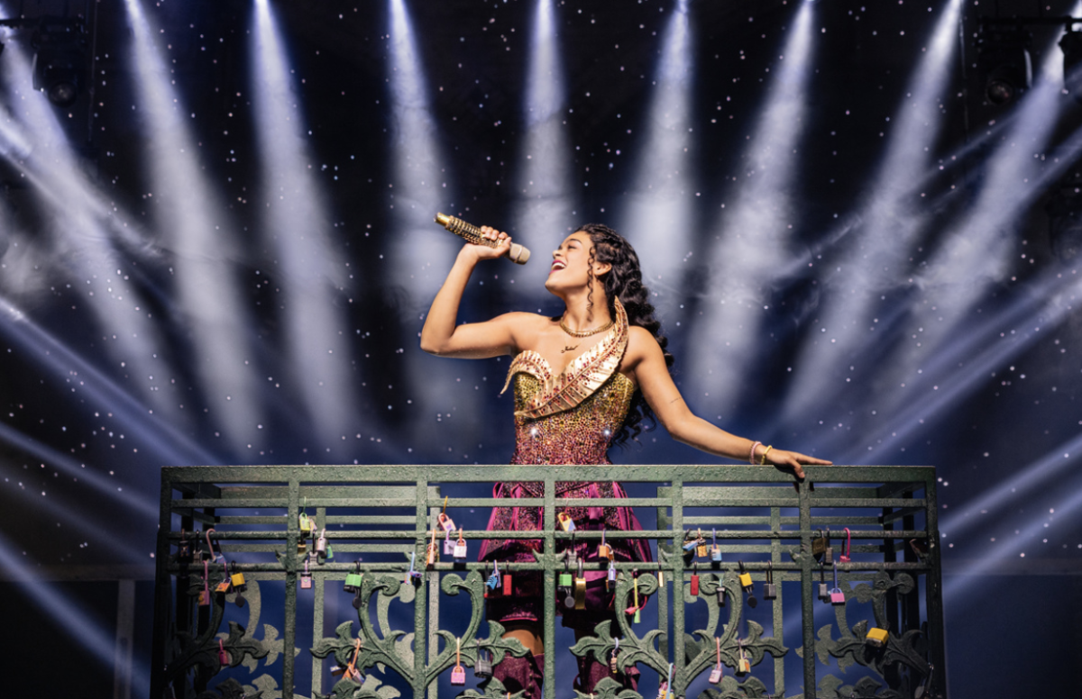 Caption: Striking a triumphant pose, Gianna Harris, who plays Juliet, stands atop a platform in “& Juliet.”