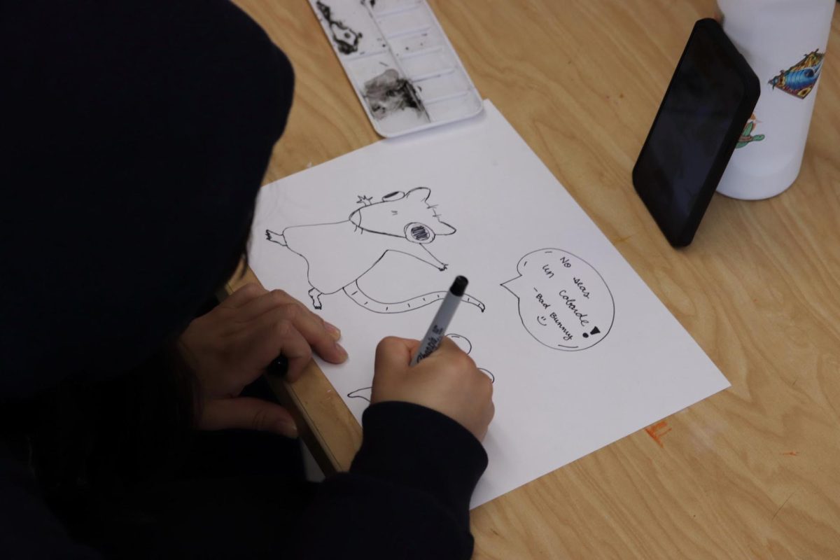Freshman Abri Gallegos is going over her drawing of a rat with a sharpie in the art room. Art Club and Mental Health Coalition held an eighth period for a chance to unwind and make watercolors, on Monday, May 11. “Art helps enable you to relieve stress and express your emotions,” Gallegos said. “[You can] open up and empty what you feel inside, but calm [yourself] at the same time.”
